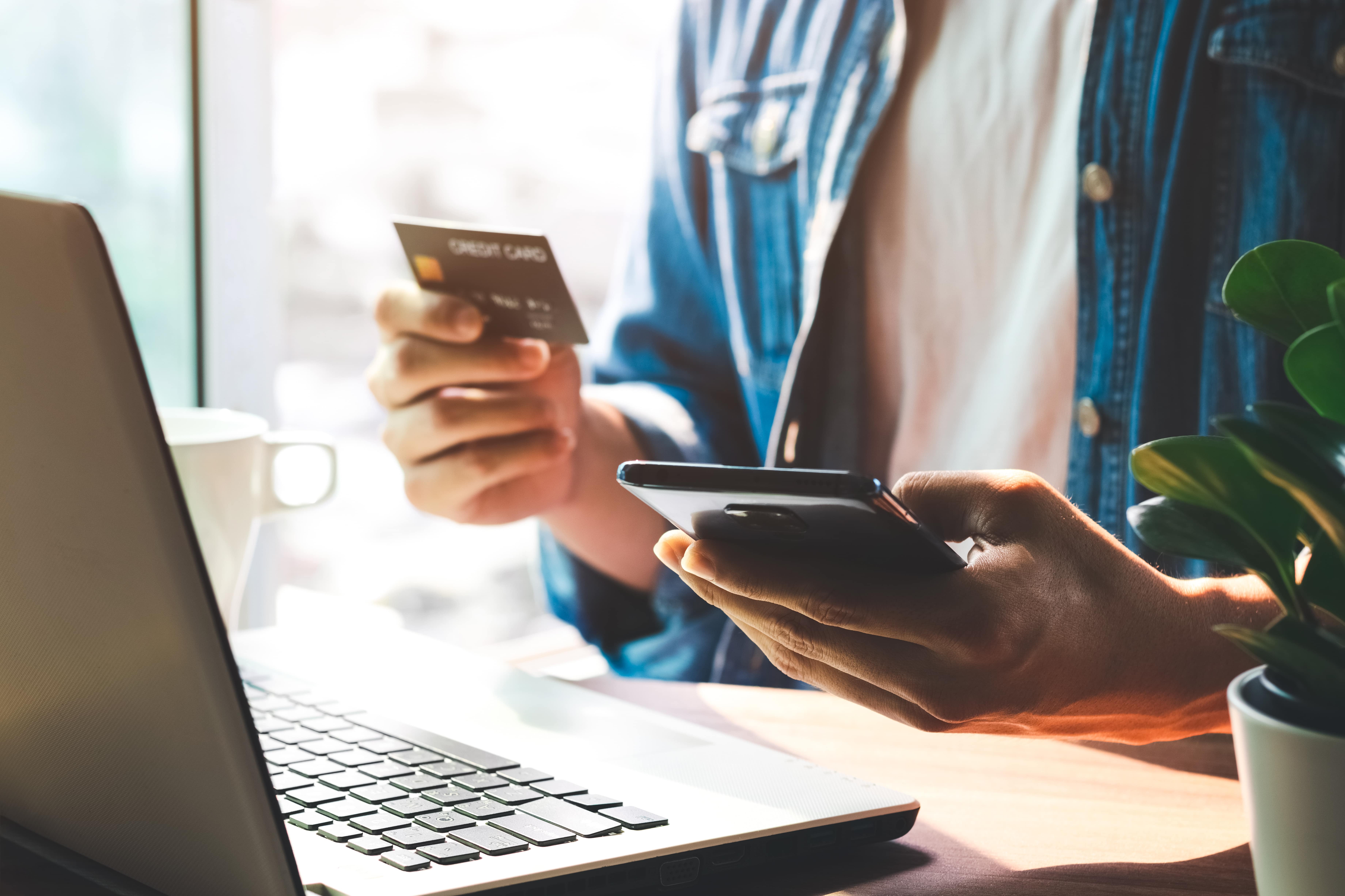 Customer shopping online with credit card and smartphone